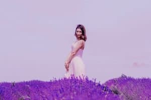photo of woman standing near lavender field
