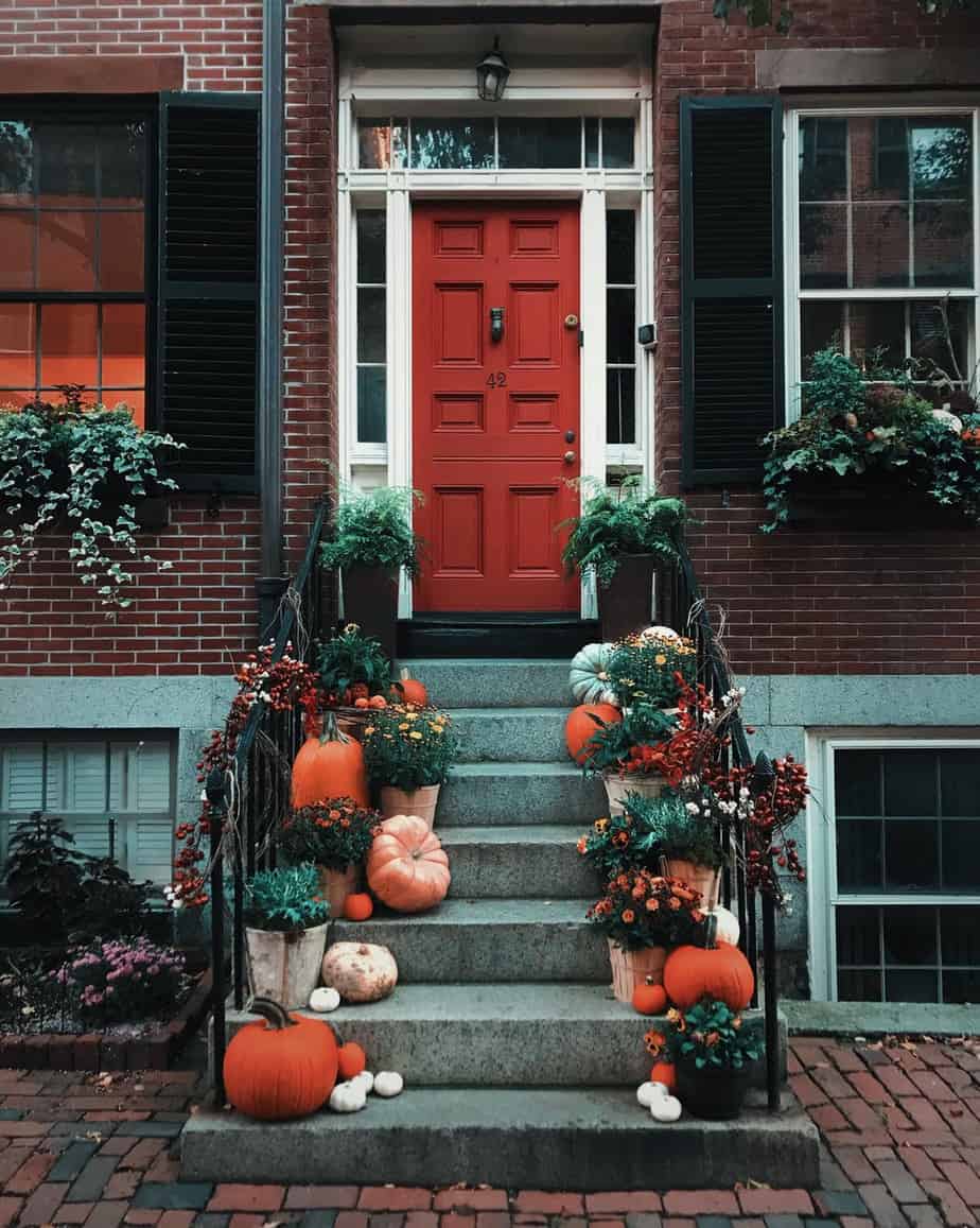pumpkins on stairs in front of a door